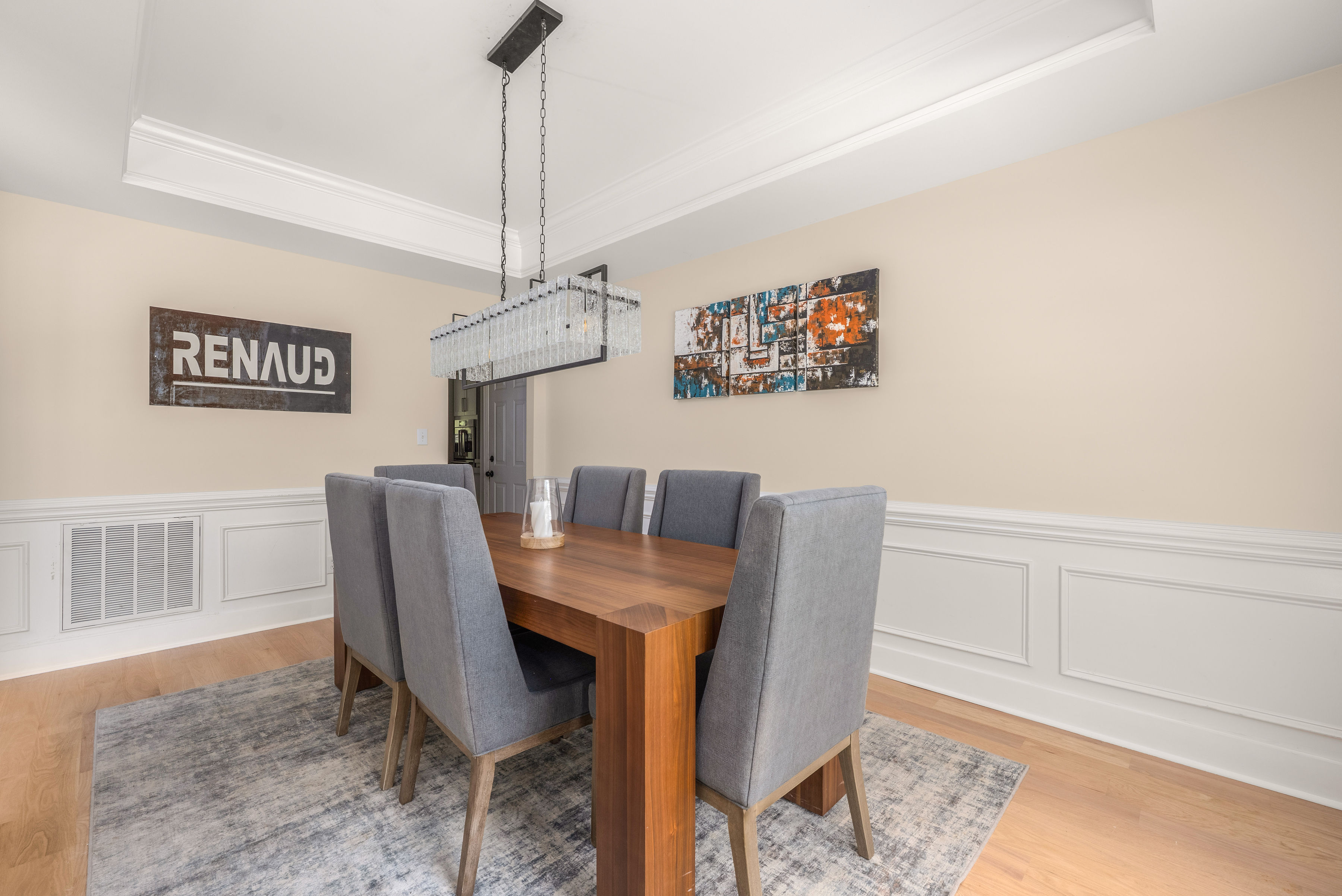 Dining room featuring a tray ceiling and elegant trim work.